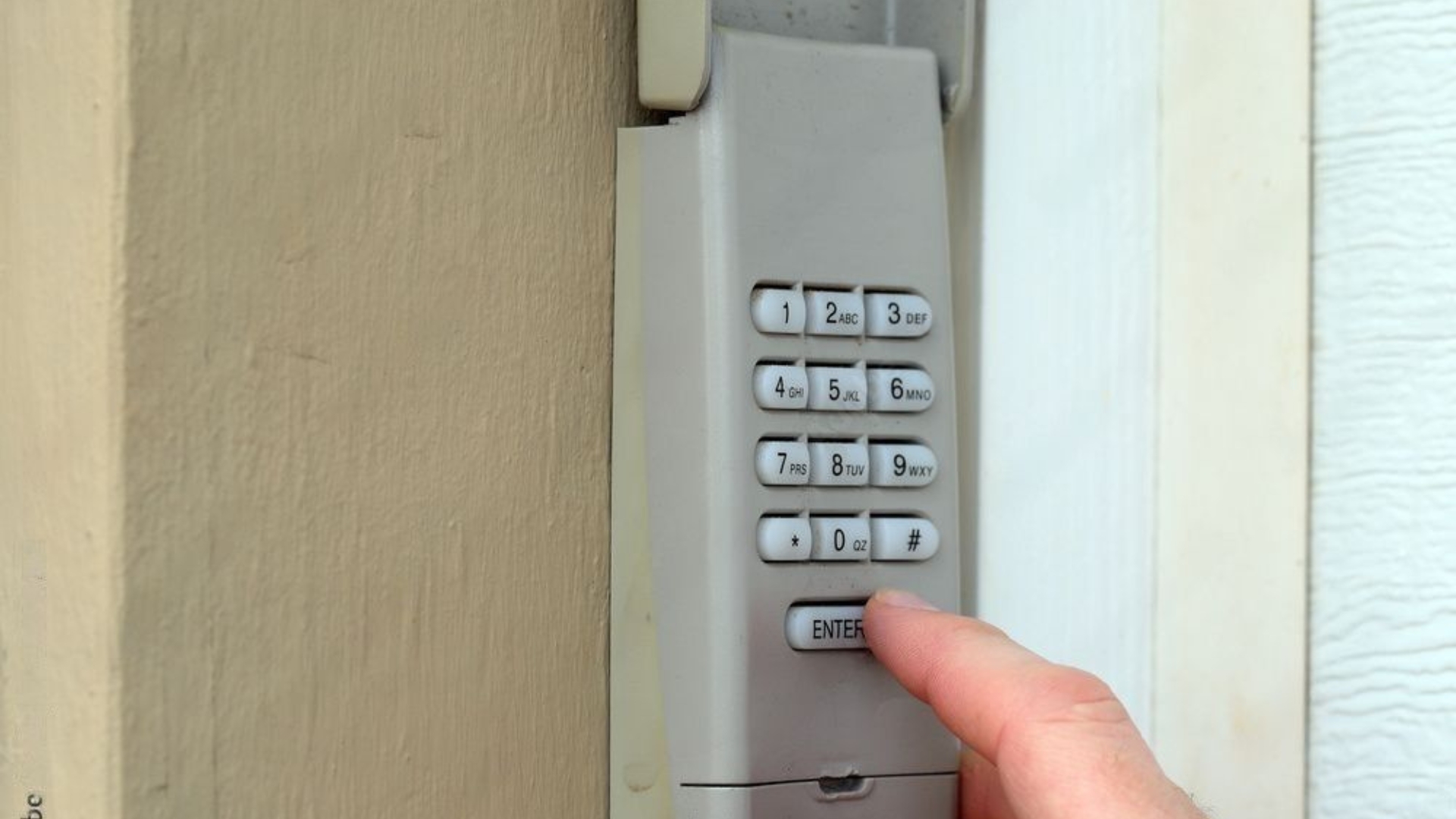 A technician testing a garage door keypad