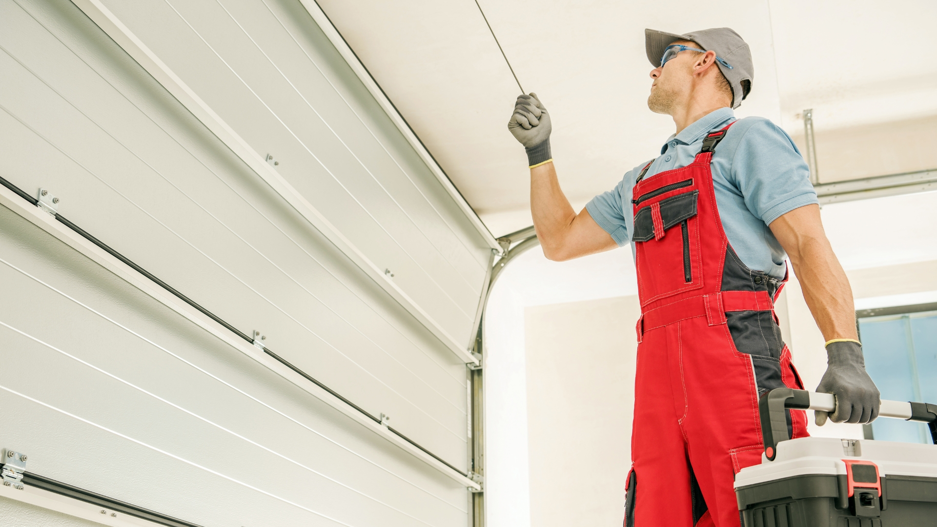 A technician testing a garage door for misalignment