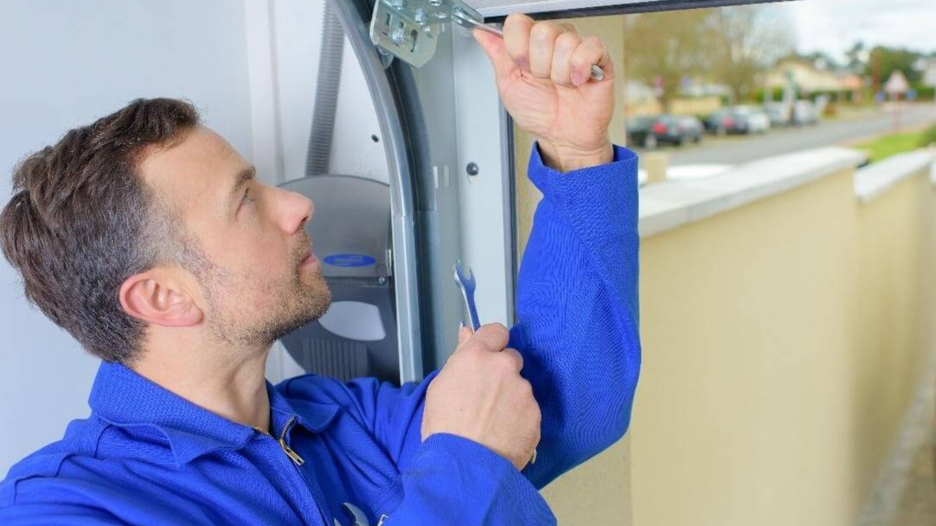 A technician working on a garage door cable replacement