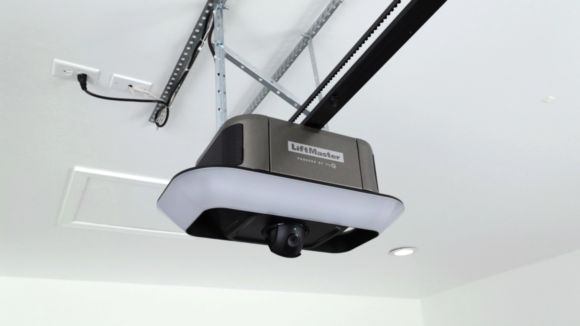 A garage door opener installed on the ceiling of the garage