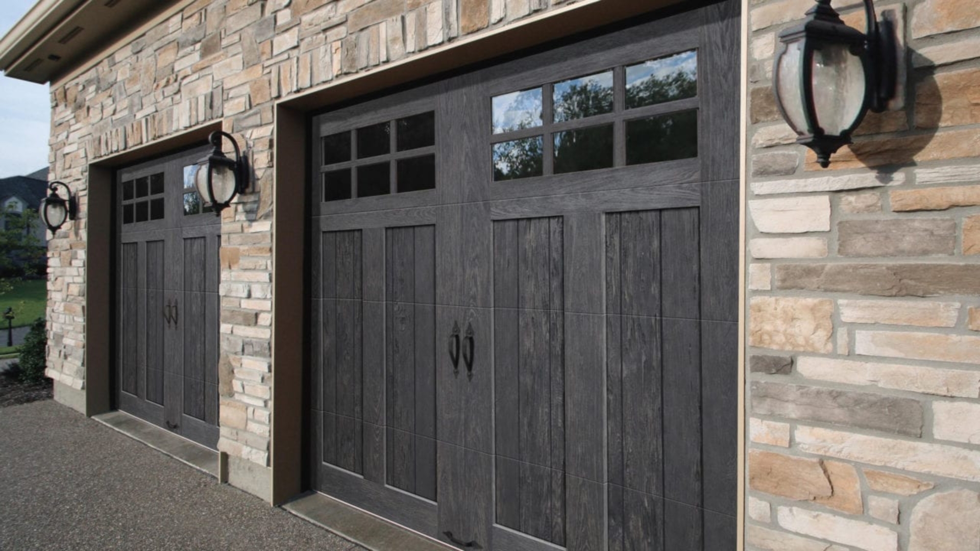 Two wooden garage doors with windows