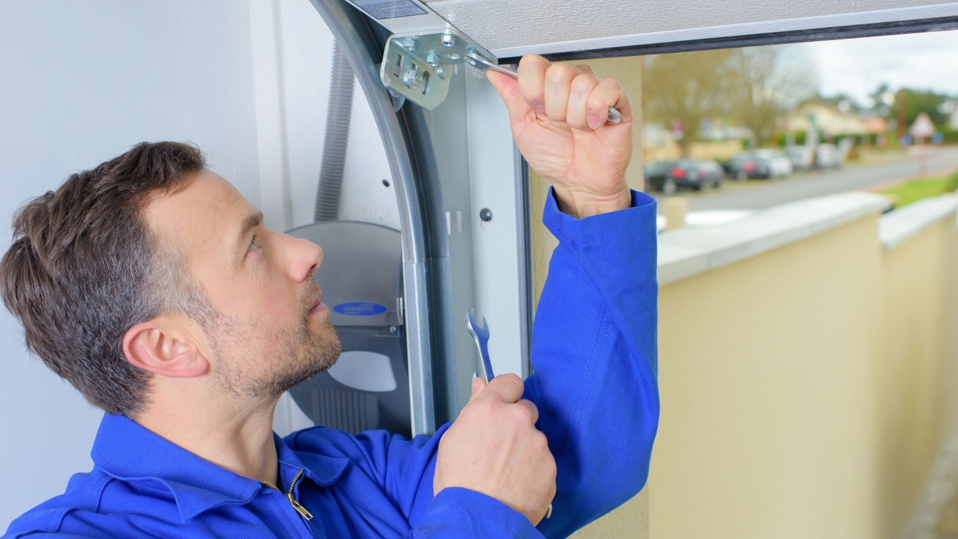 A garage door technician installing the brackets