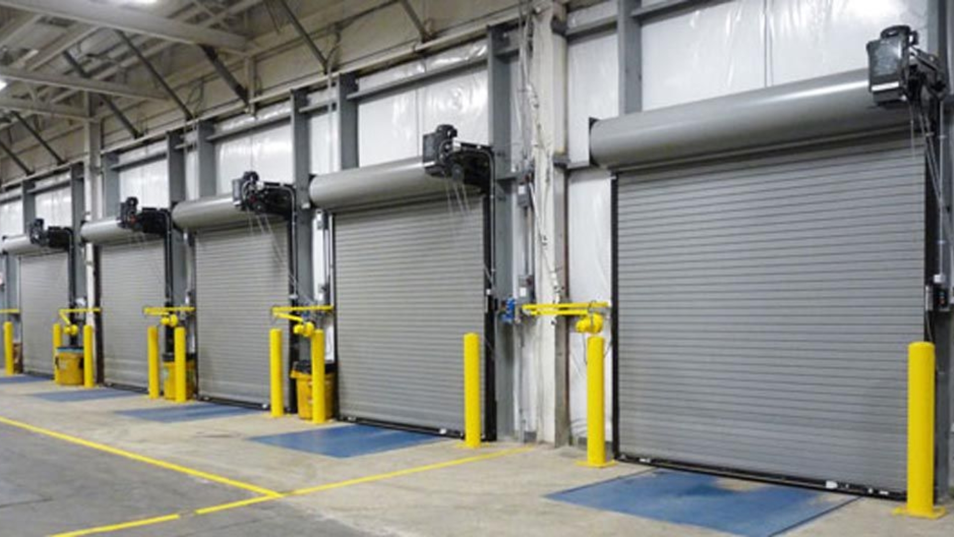 A large warehouse featuring multiple industrial roller doors for logistic operations