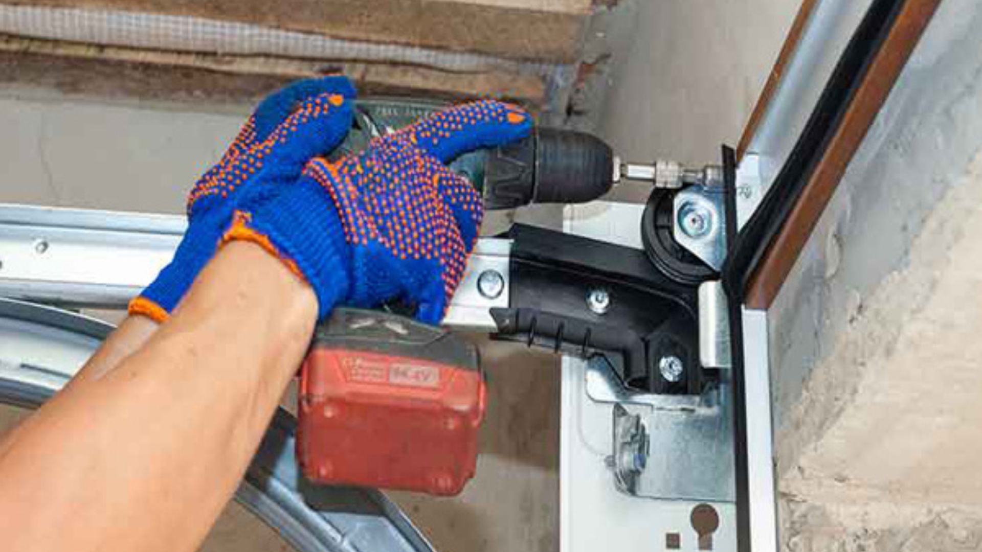 Expert technician using a power drill for a precise garage door fix